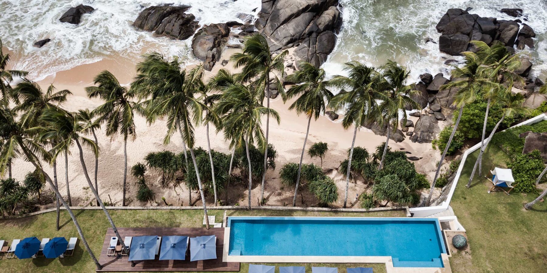 Aerial view of pool and palm trees at Kumu beach in Sri Lanka