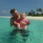 Father and daughter swimming in the Maldives