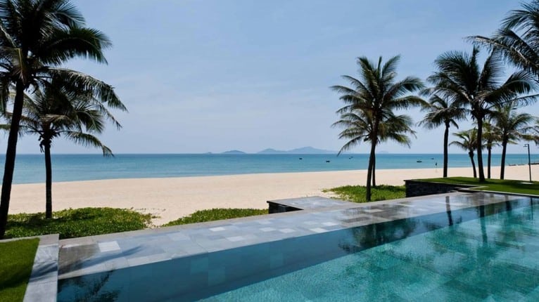 The stunning beach front and infinity pools at the Nam Hai Hotel, Hoi An, Vietnam. 