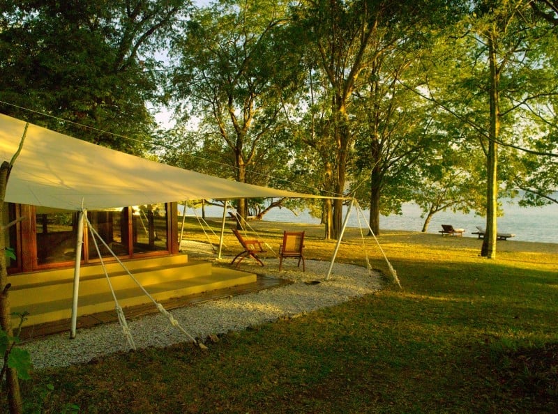 Ocean Tent at Amanwana behind the treeline on Moyo Island with deck chairs looking over the sea