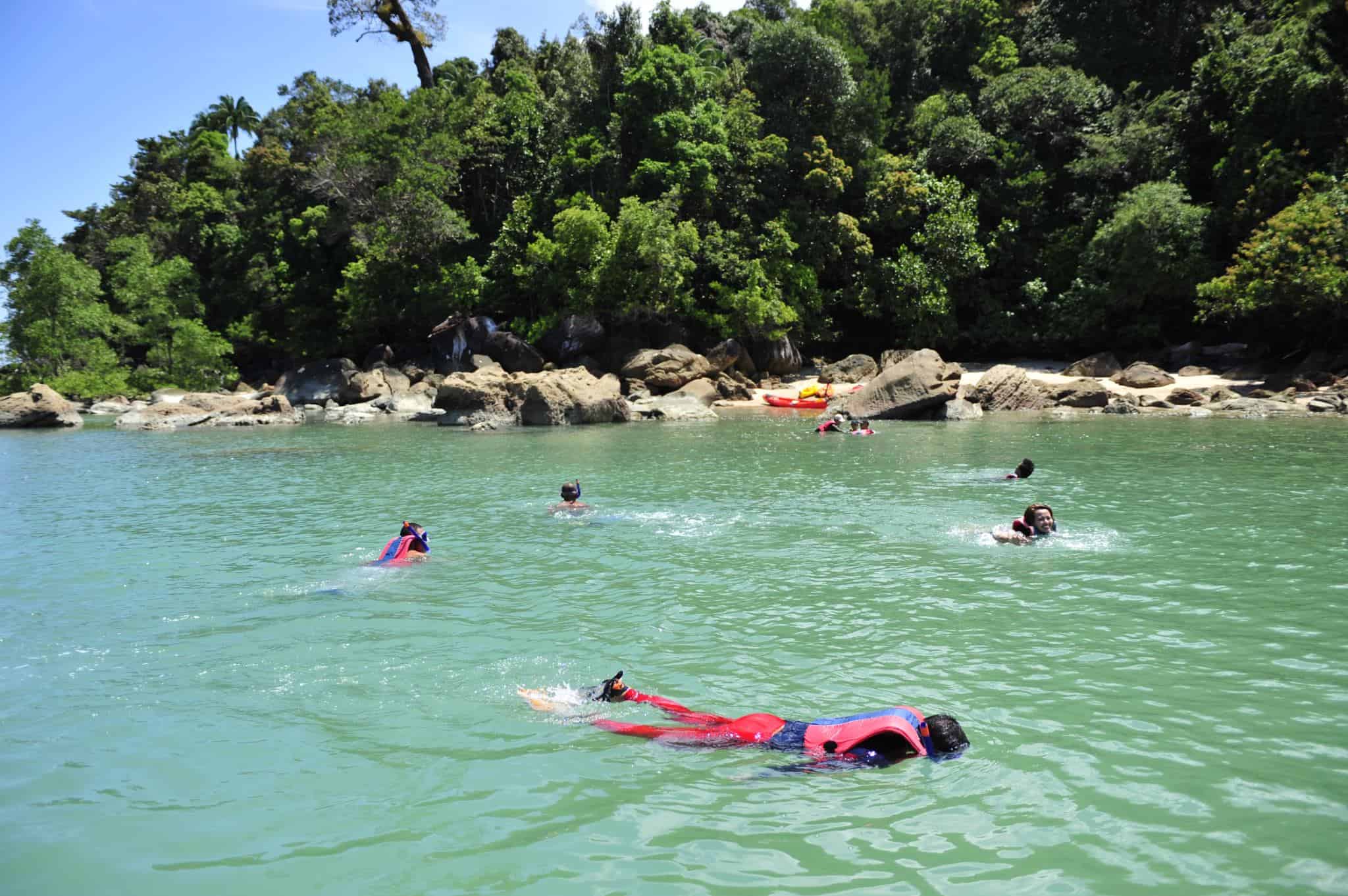 A family snorkelling off Permai Rainforest Resort in Sarawak near Kuching