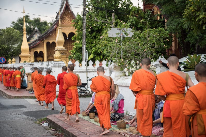 Monks walking in the complex of Wat Xieng Thong. Wat Xieng Thong is the oldest temple in Laos and is one of the most important buddhist shrine among all other Lao monastries.