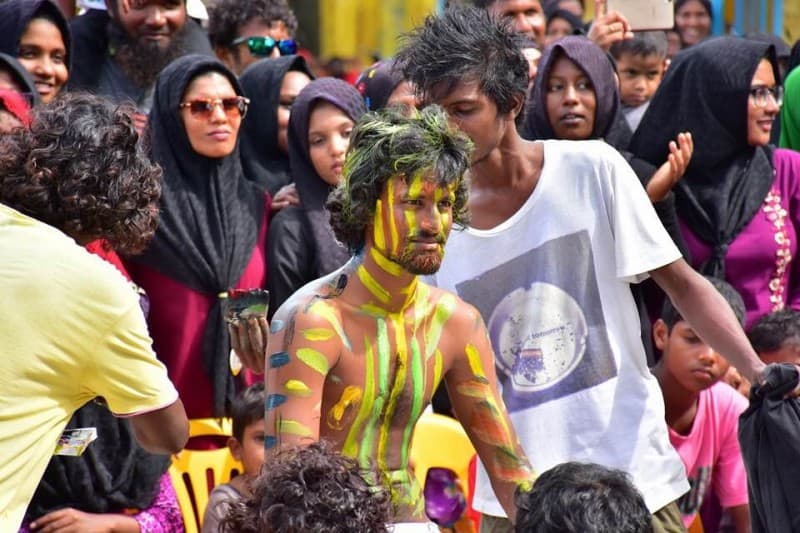 locals celebrating Eid Ul Al’haa. Crowds surround a main painted in different colours