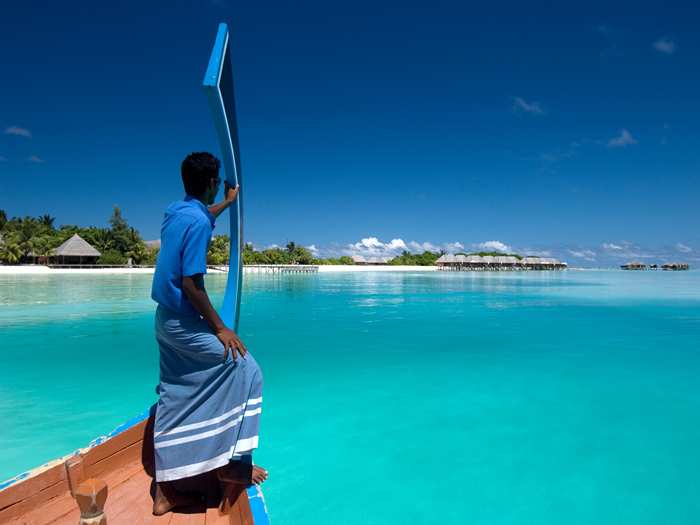 A local steering a dhoni as they enter a resort in the maldives