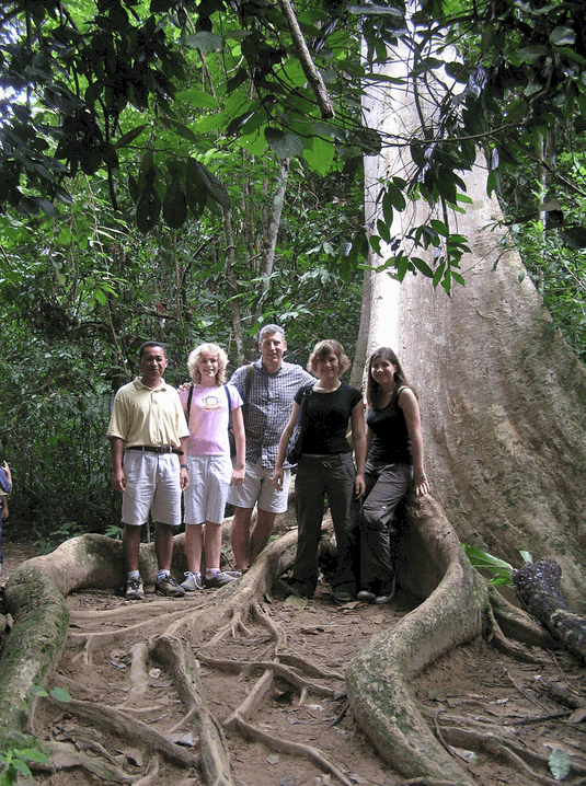 A family in Taman Negara in Malaysia under a huge tree