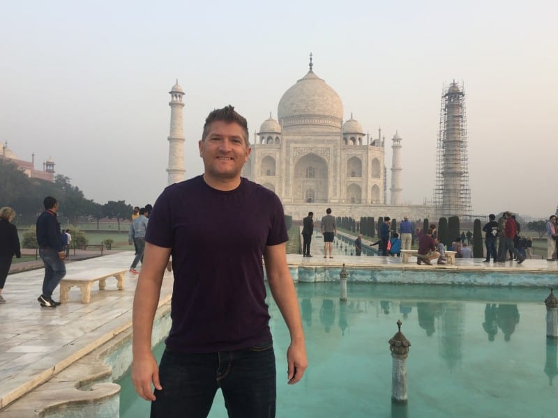 Robin Mckelvie in front of the Taj Mahal at sunrise