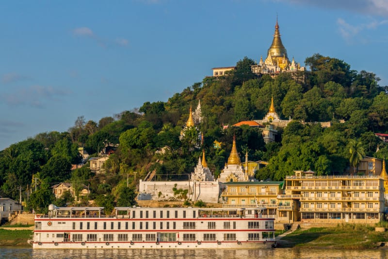 Sagaing, Myanmar - November 19: A cruise ship stops in front of a temple hill in the old capital Sagaing at sunrise. November 19, 2014 in Sagaing, Myanmar