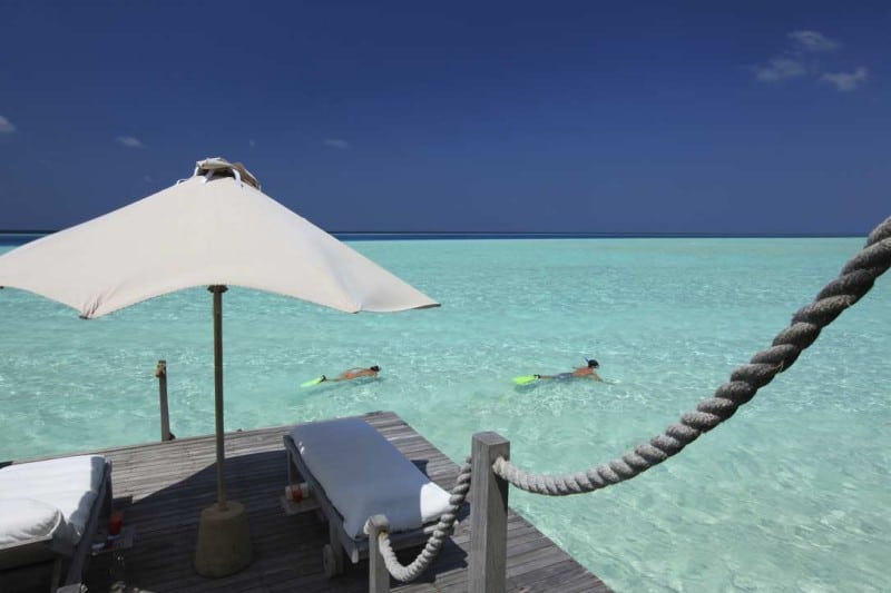 Snorkeling from the deck of your private over water villa in the Maldives