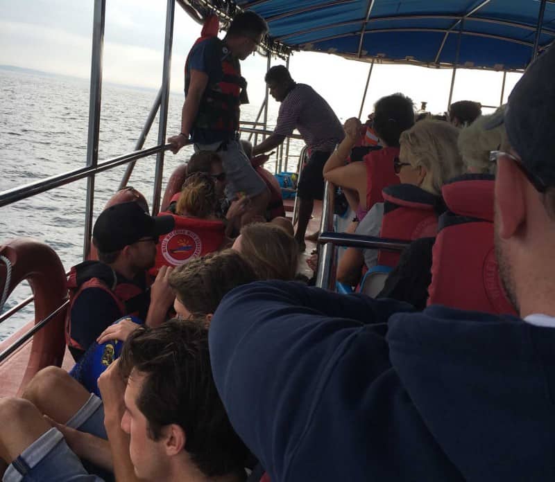 tourists on a crowded boat whilst whale watching