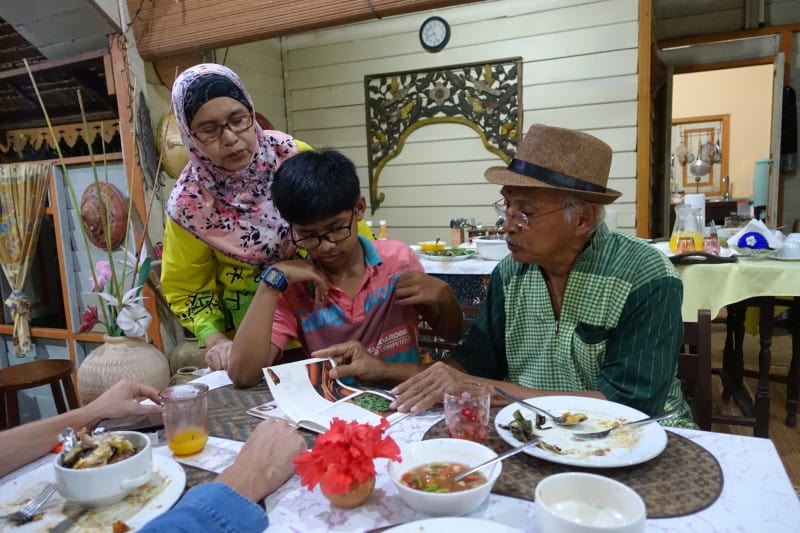 The owners of Suka Suka Homestay sat eating dinner