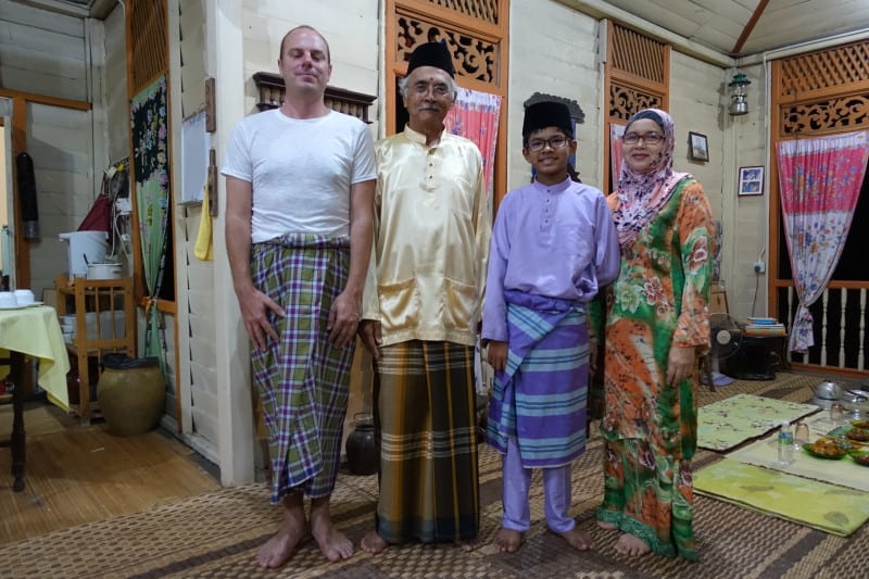 Traveller with Malay family dressed in traditional clothes