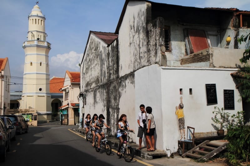 Tourists on Lebuh Cannon & Lebuh Acheh in George Town, Penang in front of Aceh Mosque