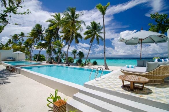 Pool and beach view at Amilla Resort in the Maldives