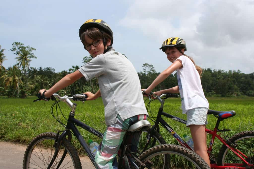 Children on bikes exploring the countryside of Gampaha