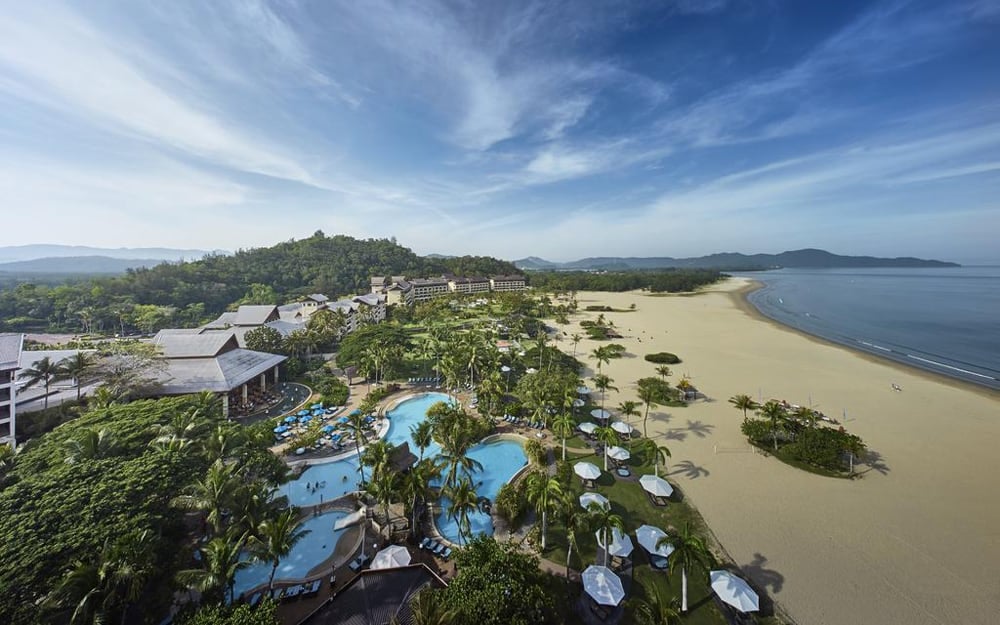 Birdseye view of the white sandy beach of Shangri La Rasa Ria and its swimming pools