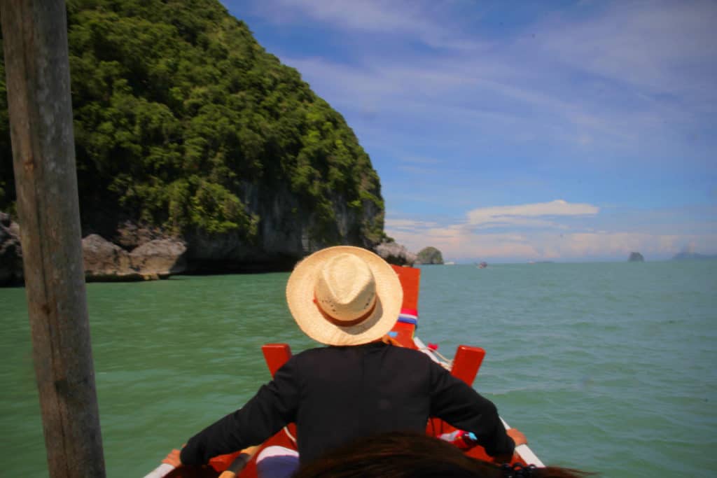 Traveller on a boat ride around the coast of the Khanom searching for pink dolphins