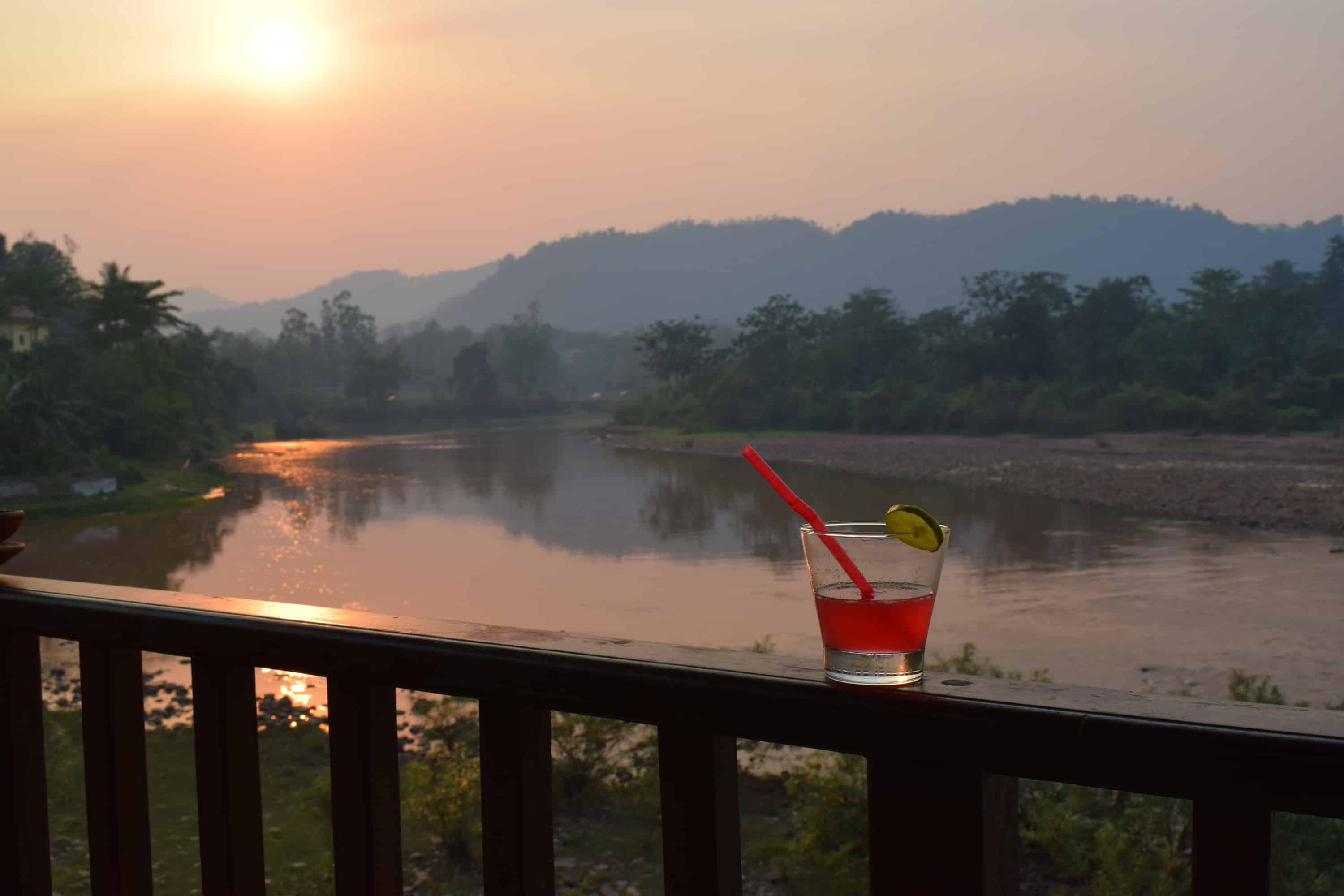 Cocktails on the terrace at Muang La Resort in Laos as the sunsets