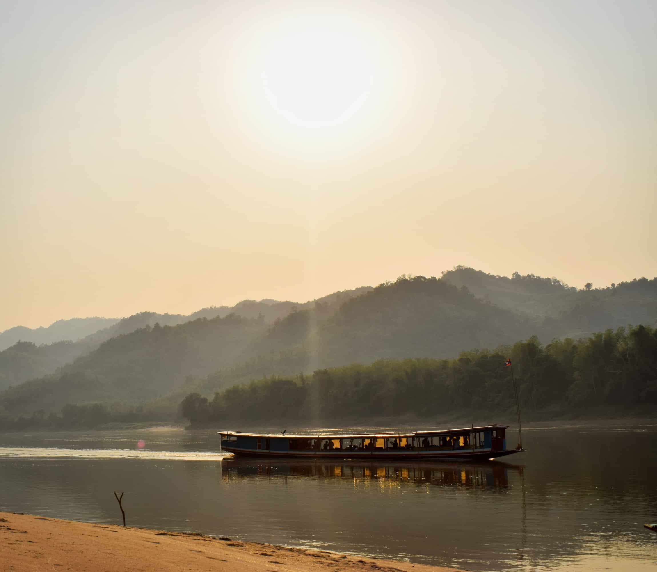 Sunset as a boat sails down the Mekong River in Laos