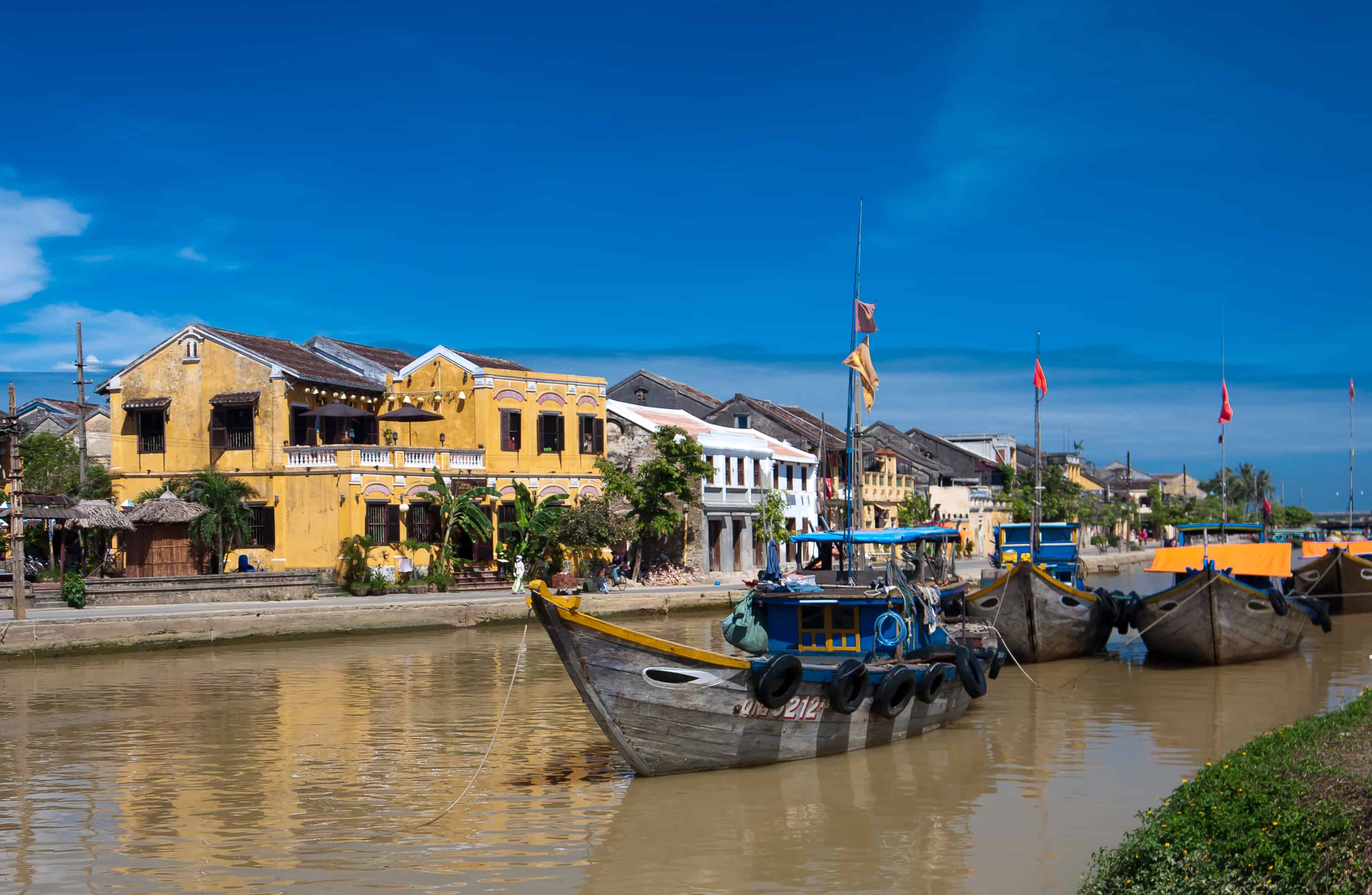 boats on the banks of Thu Bon River in Vietnam