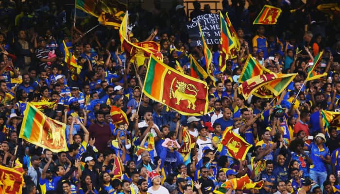 Sri Lankan cricket fans celebrating and waving flags