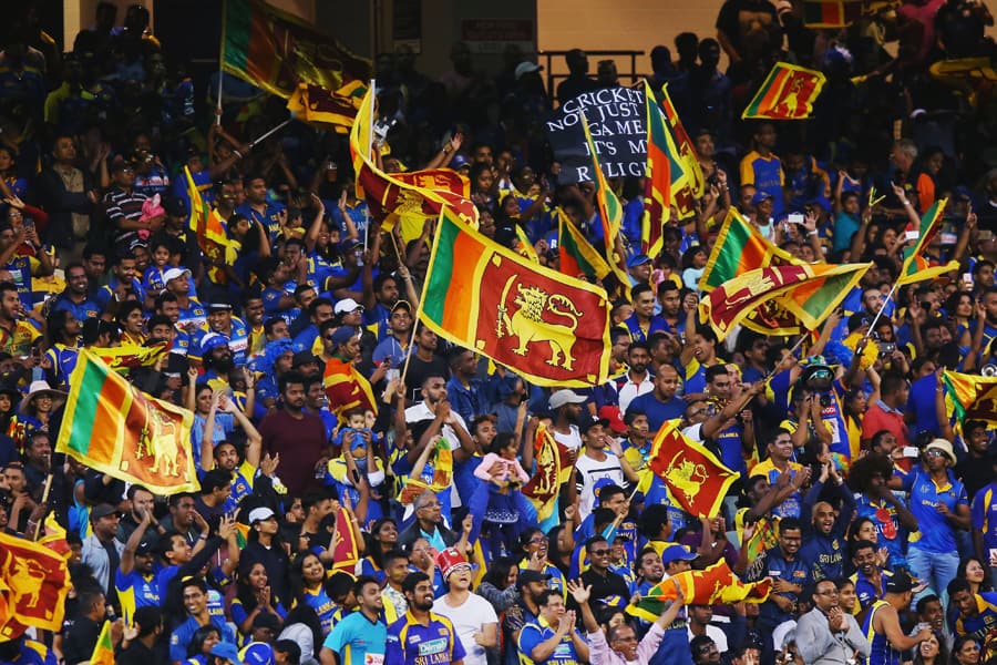 Sri Lankan cricket fans celebrating and waving flags