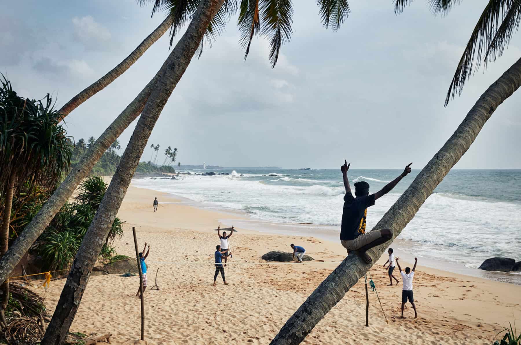 Locals having fun playing cricket on a Sri Lankan Beach