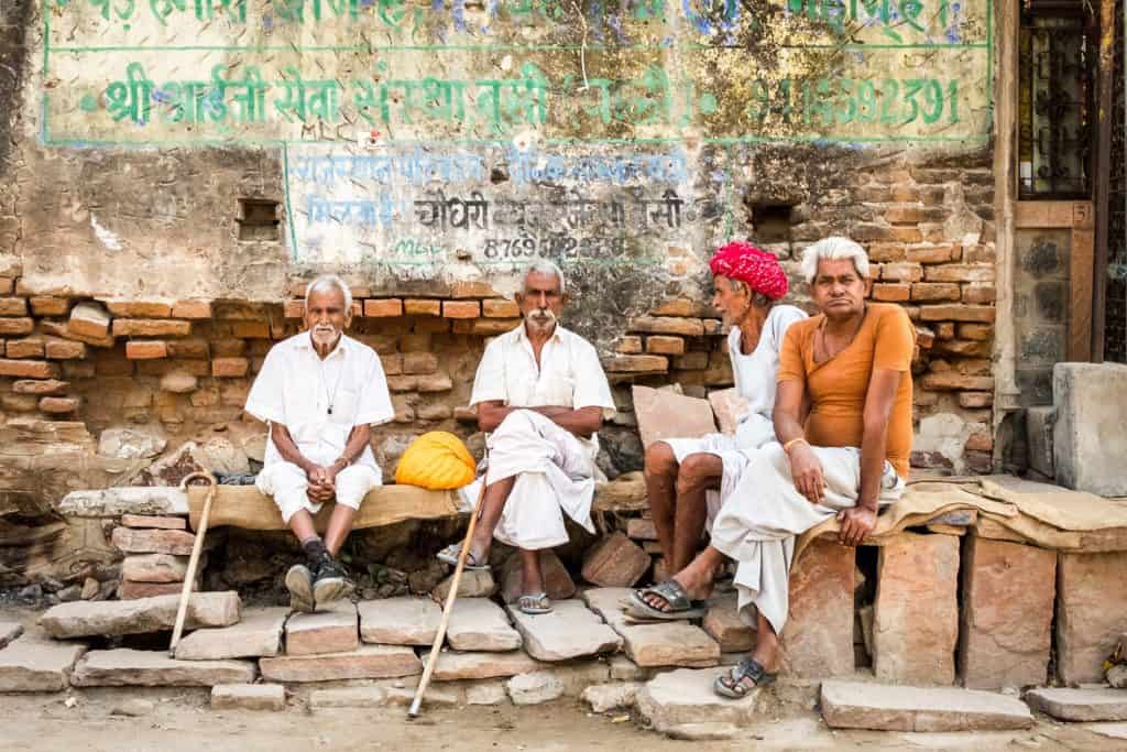 Four elderly gentlemen in a village in Rajasthan wearing traditional clothing