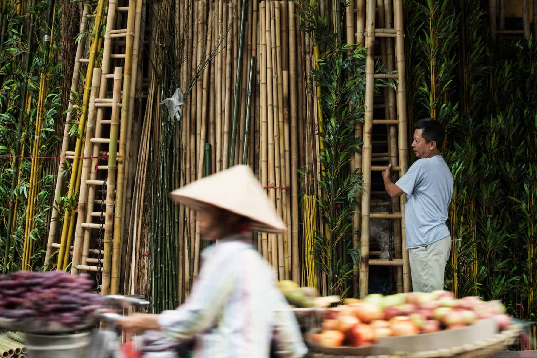 A market in Vietnam - a local pushing bike with traditional conical hat on