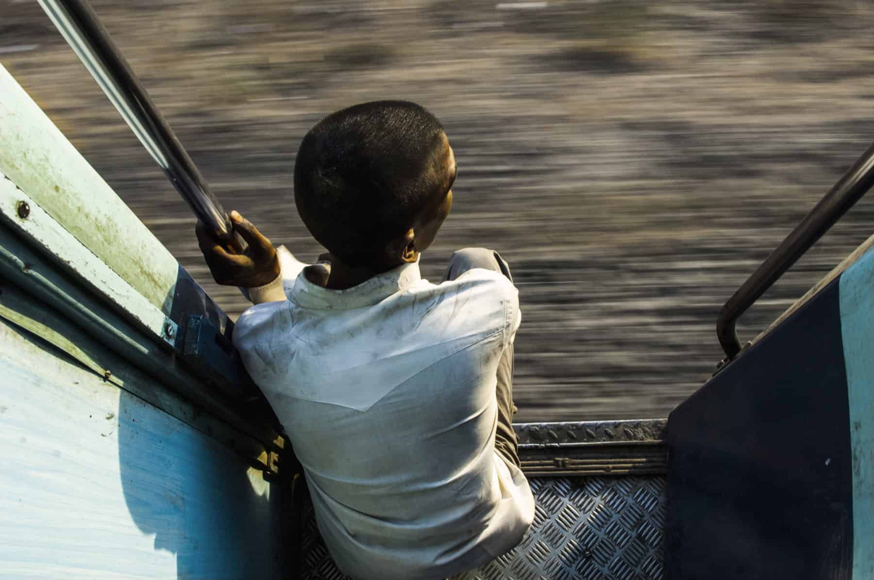 a passenger in a train looking outside, india