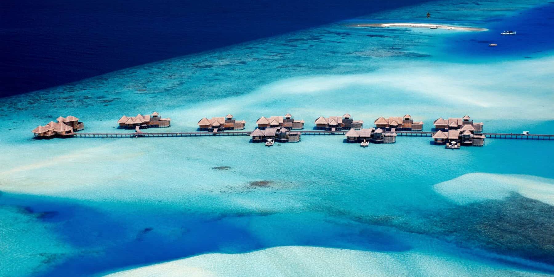 Aerial view of overwater villas and turquoise ocean in the Maldives
