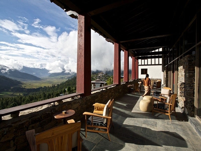 Balcony of Gangtey Lodge looking onto Gangtey valley with clouds in the sky