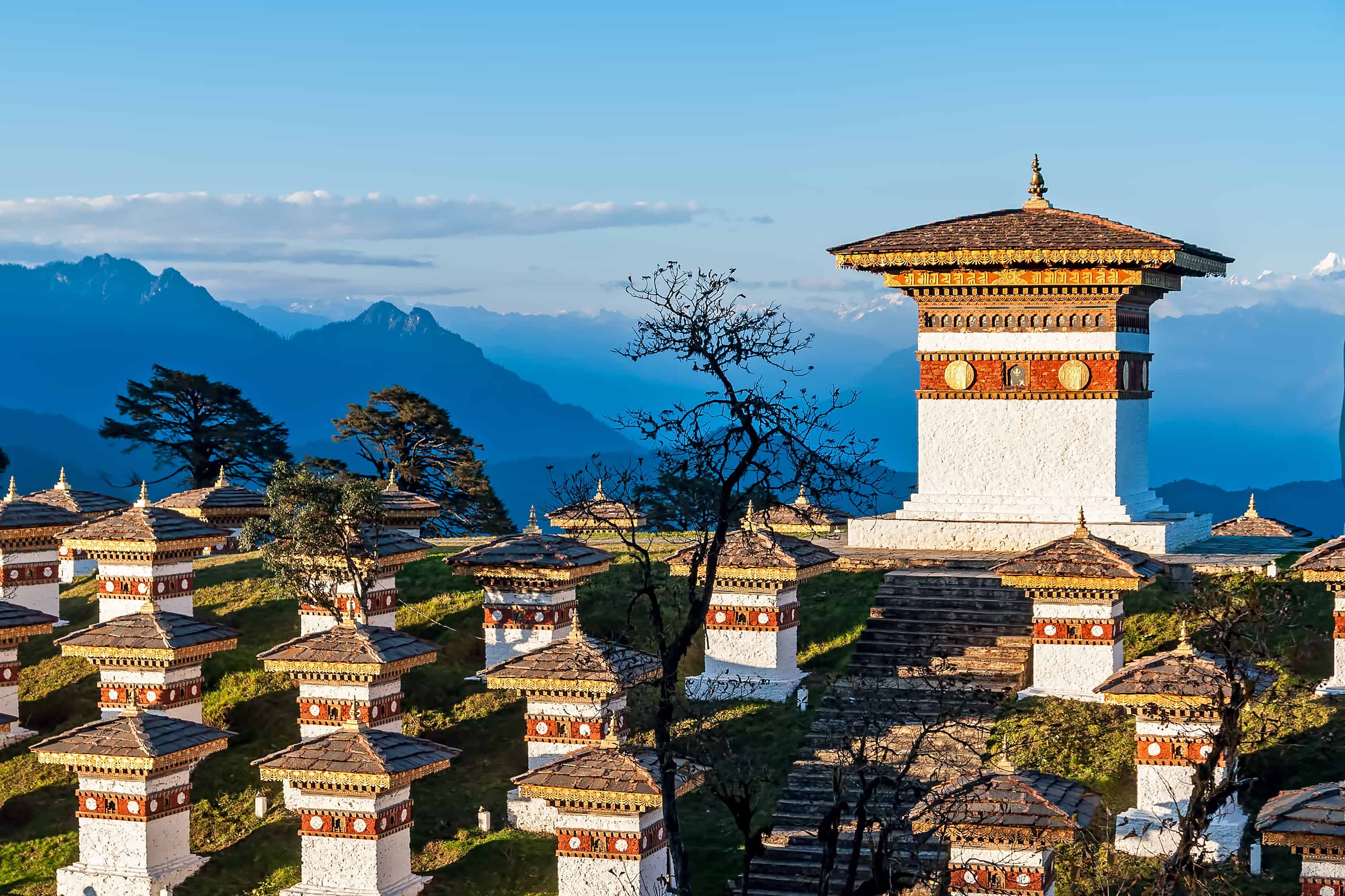 Sunset Dochula Pass Memorial Chortens in Bhutan with mountains in the background