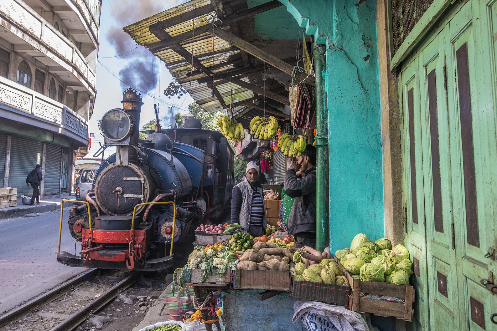 Toy train passing through a market in Darjeeling