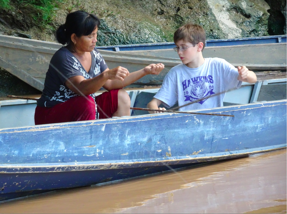 Boy connecting with local people in Sapulot, Borneo