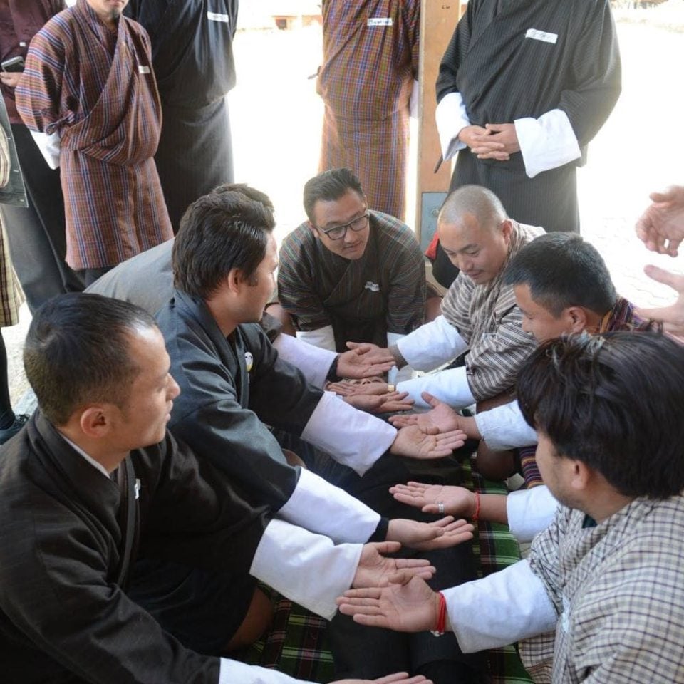 Men praying in Bhutan