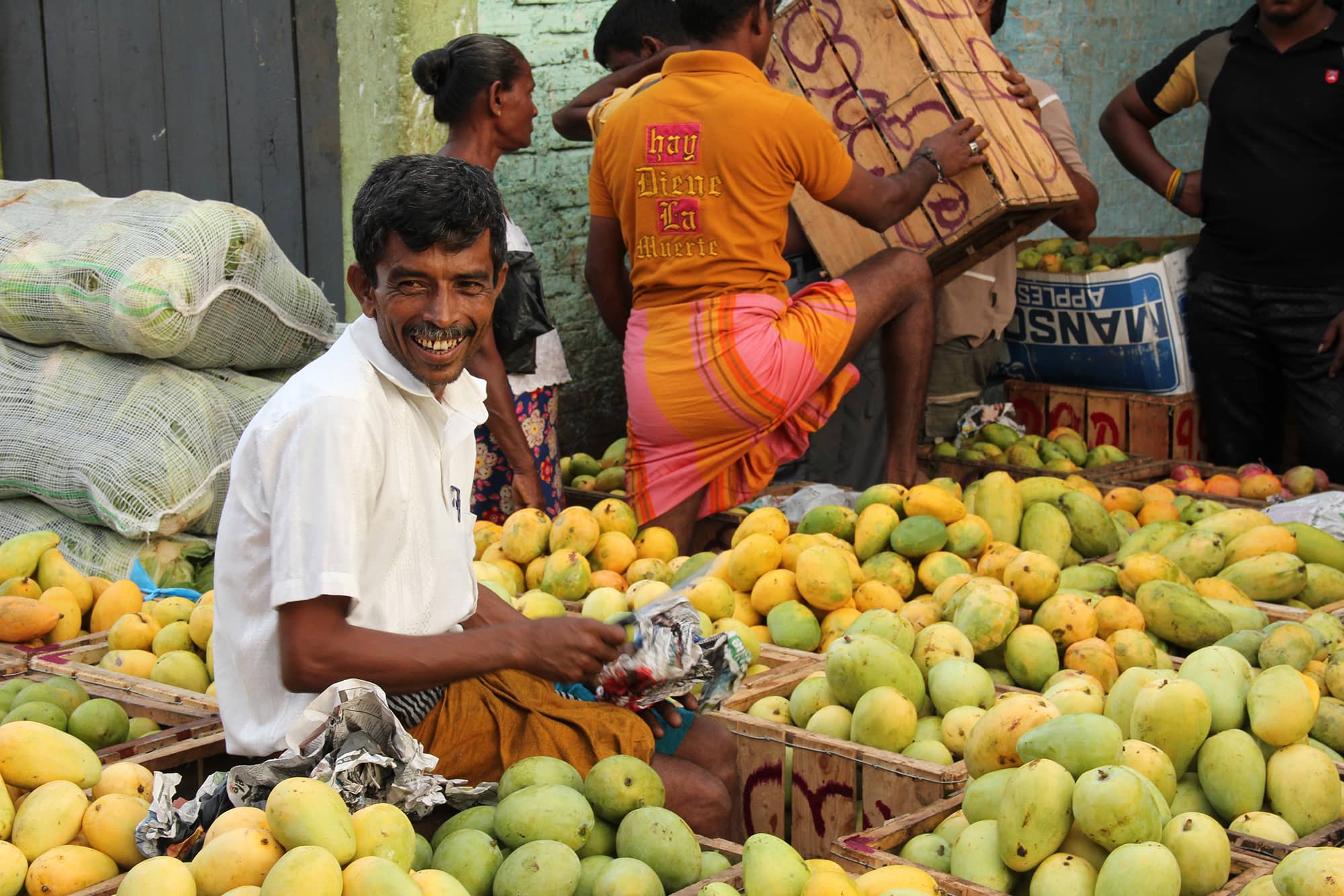 Mango trader in Sri Lanka with a smile on his face