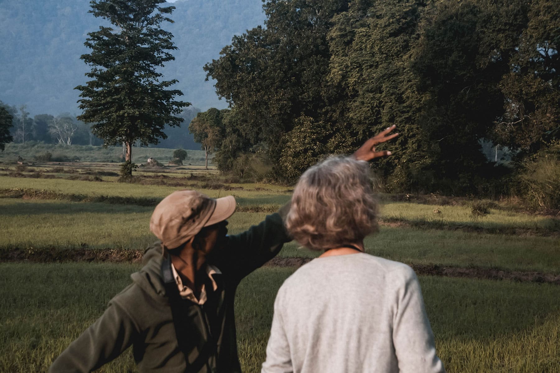 Guide pointing out birds to a traveller in Sri Lanka