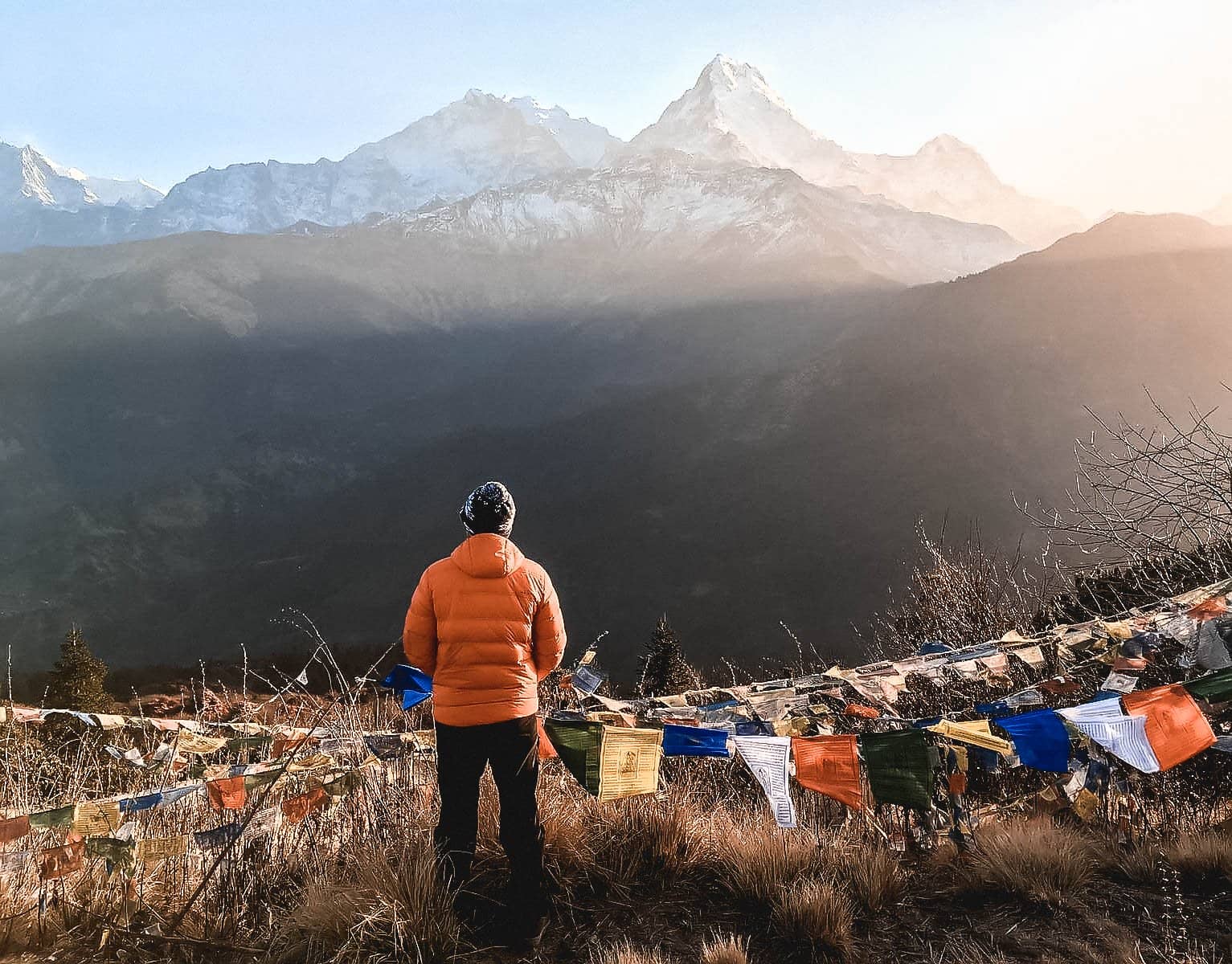 Traveller with prayer flags in the Himalayas