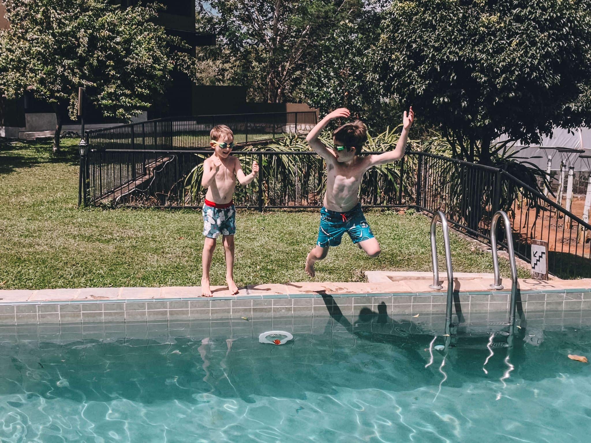 Kids jumping into a pool on a family holiday to Asia