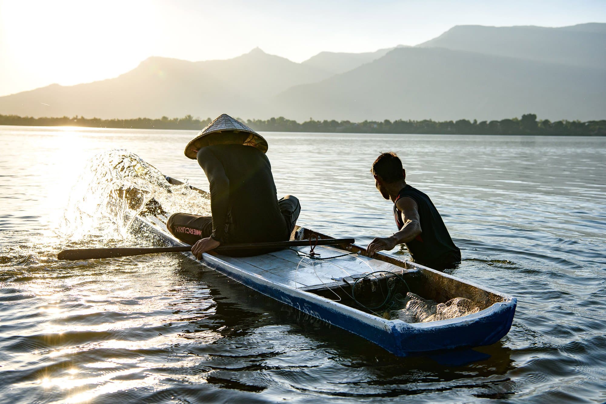 Fishermen pushing out their boat from Don Daeng in Laos at sunrise