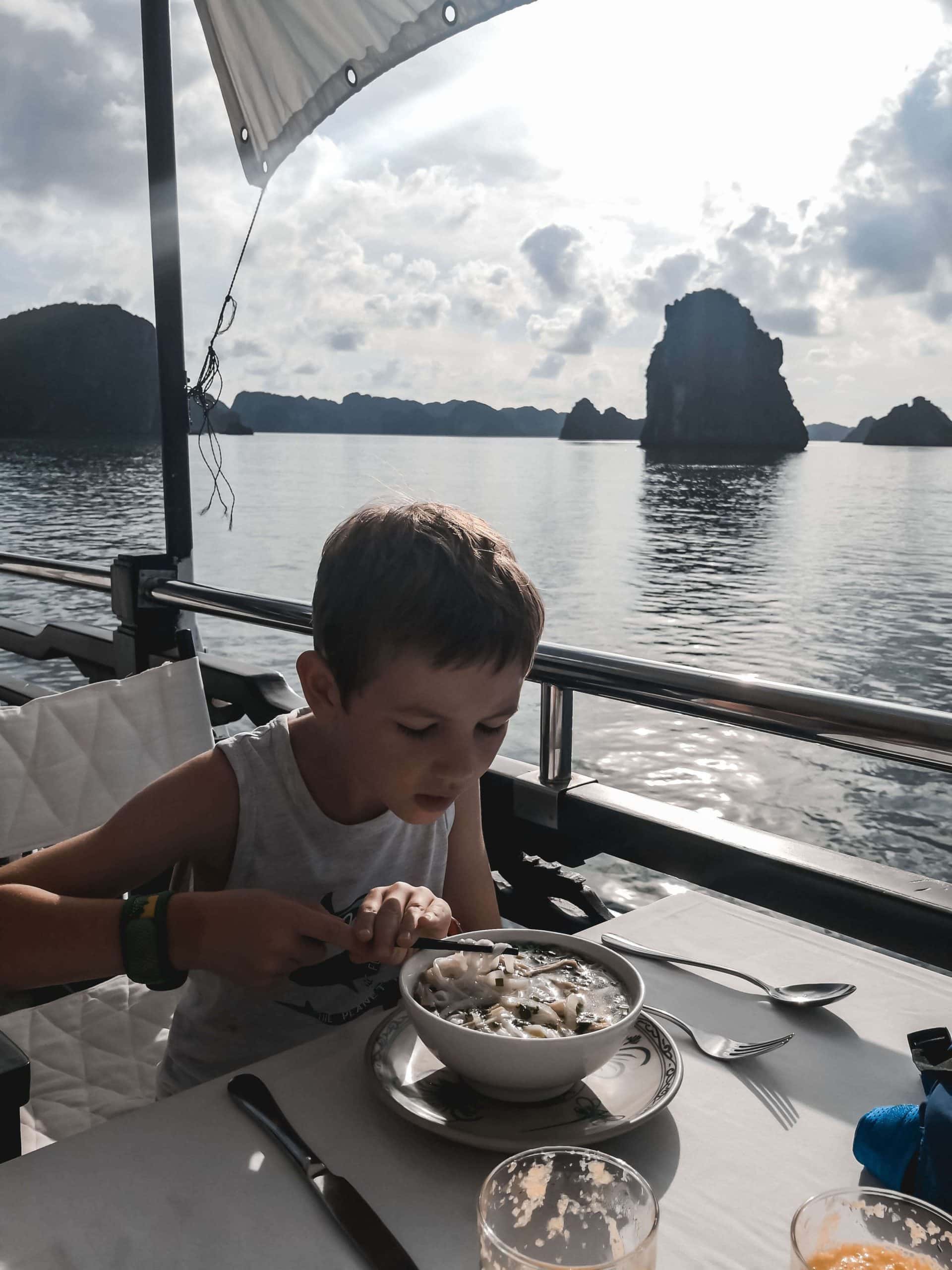 Having lunch whilst cruising Ha Long Bay on a family holiday to Vietnam