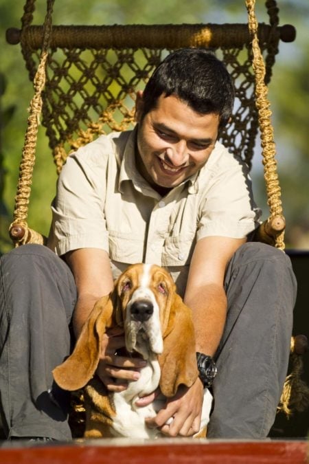 In country partner with his bassett hound in Bhutan