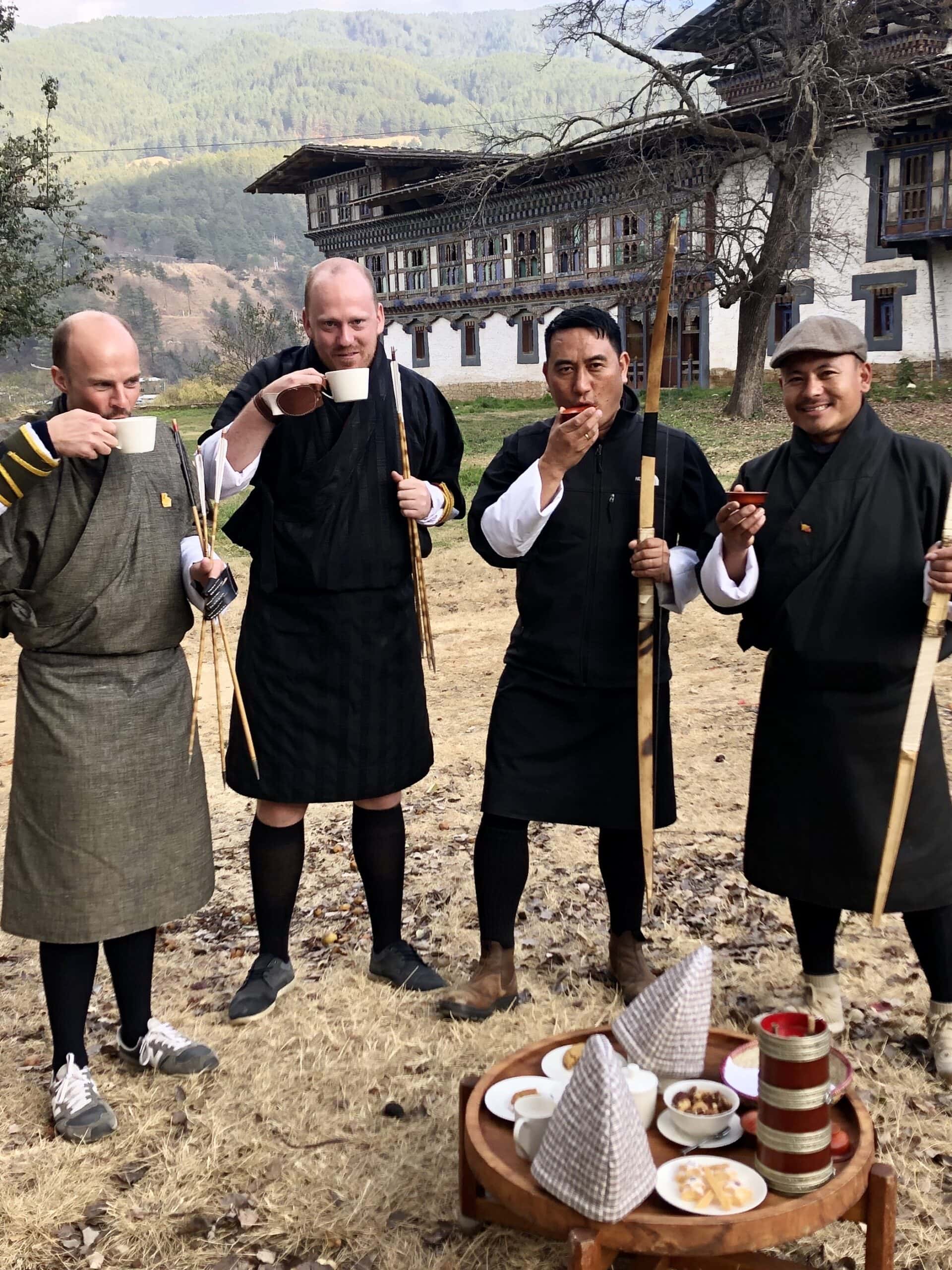 Travellers and guides taking a break from archery at Aman Bumthang in Bhutan