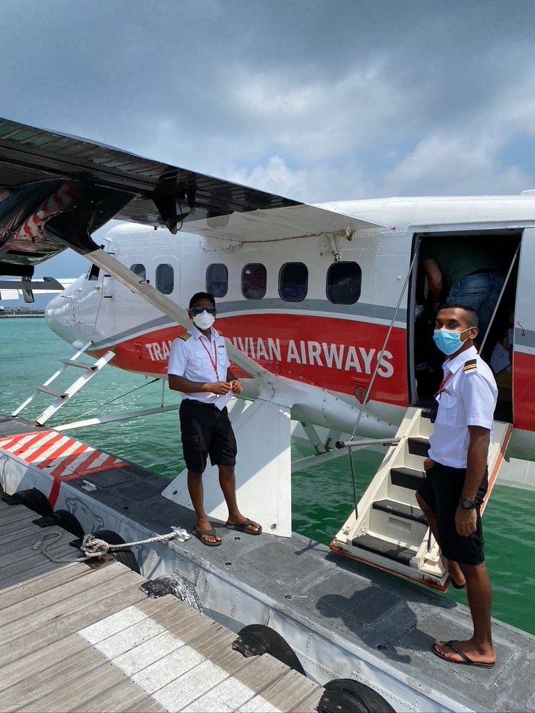 Travel on a seaplane in the Maldives with staff wearing covid face masks