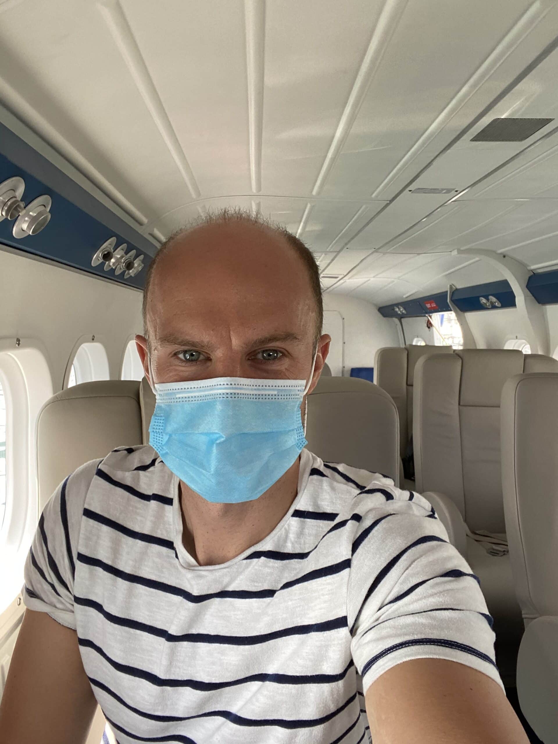 Tourist wearing a mask on a seaplane to The Maldives
