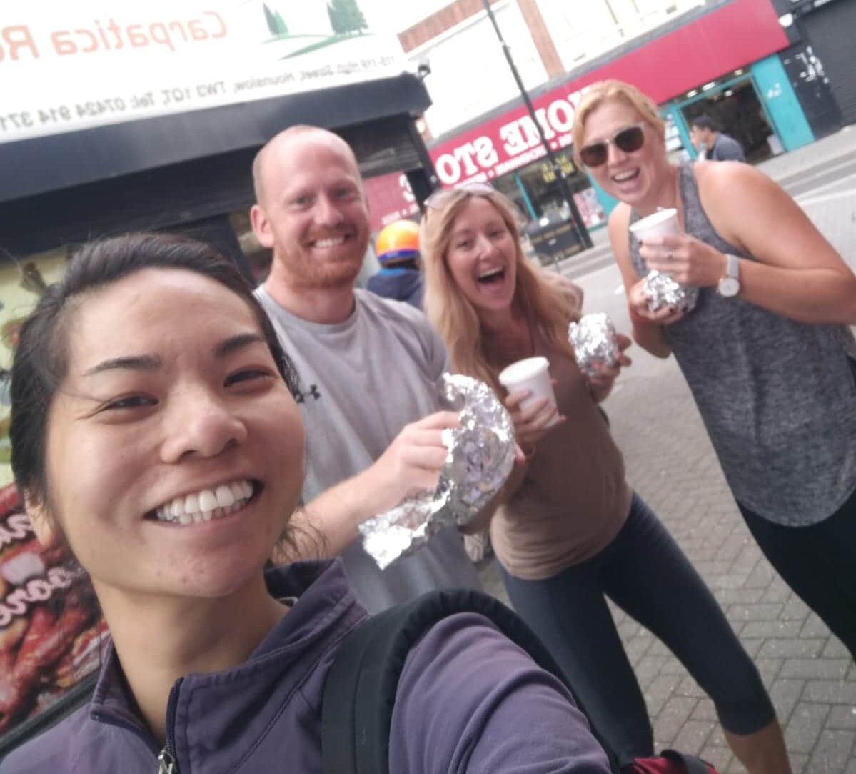 Four people smiling in London