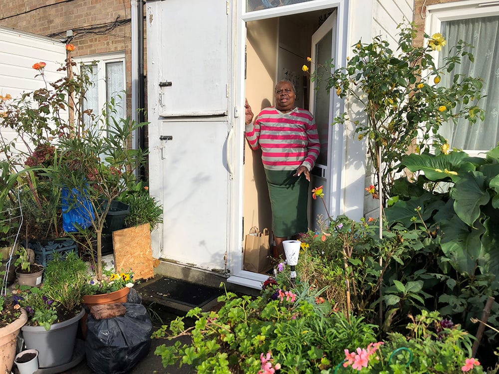 Woman standing at doorway in garden