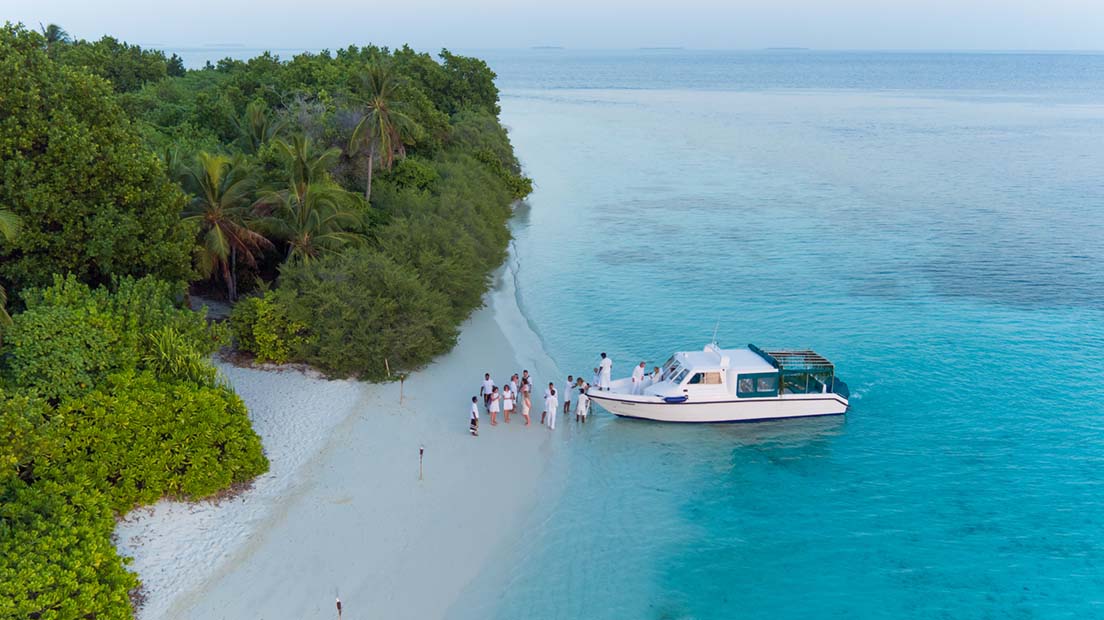 Boat on the beachside with travellers from Soneva Fushi island in the Maldives