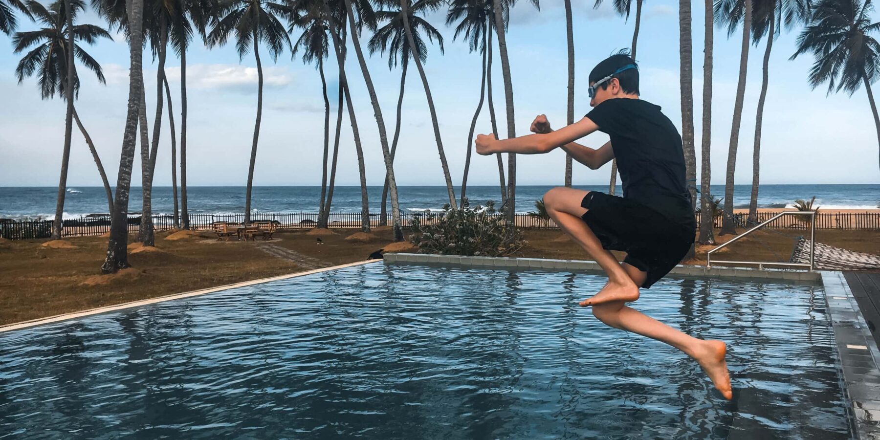 16 year old felix on holiday in Sri Lanka jumping in a pool at Jetwing Arugam Bay