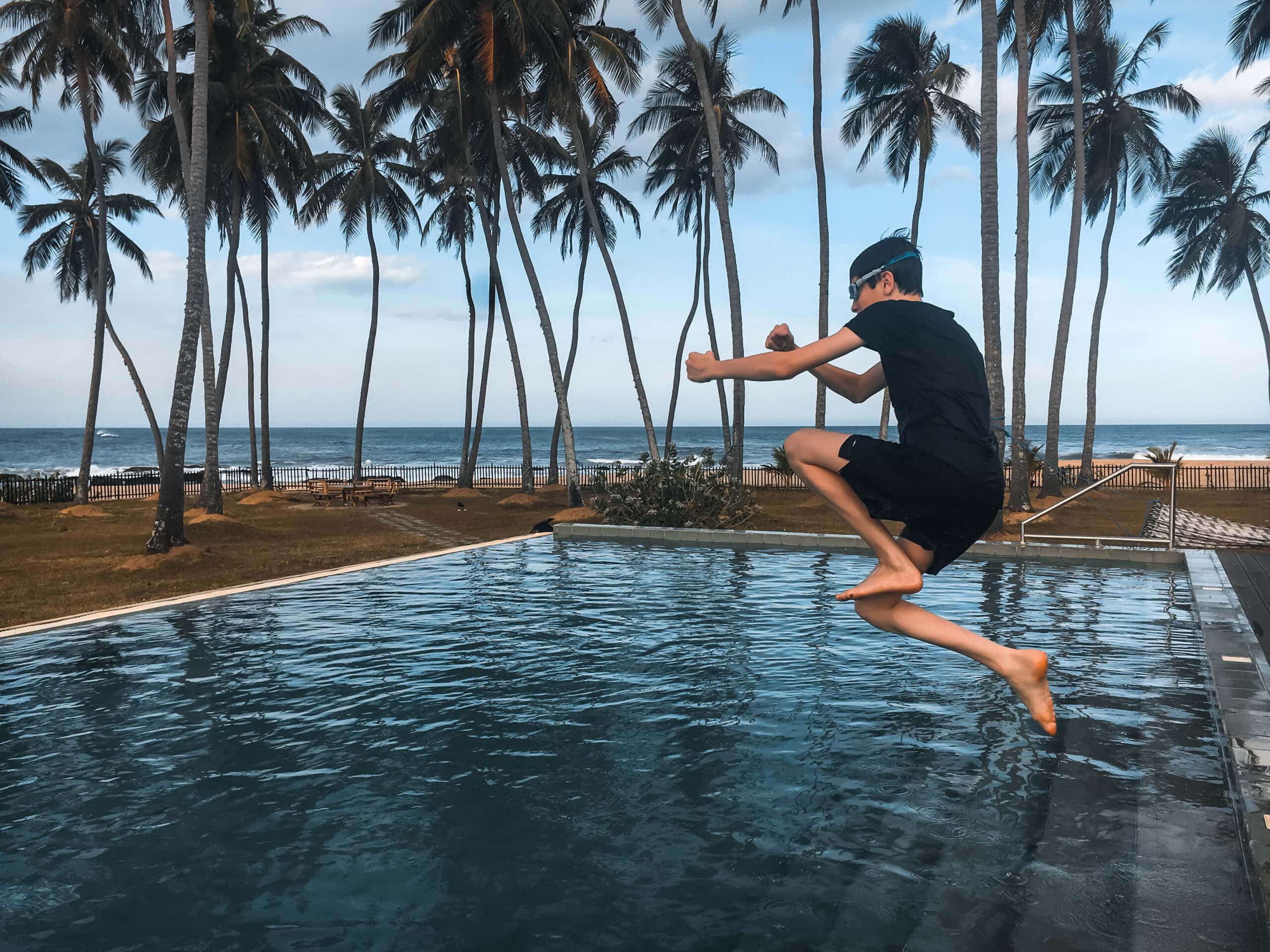 16 year old felix on holiday in Sri Lanka jumping in a pool at Jetwing Arugam Bay